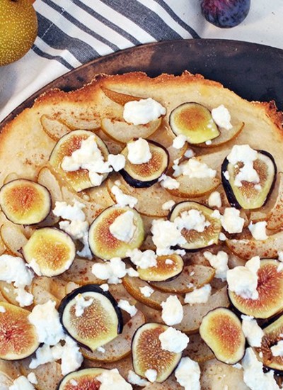 Above view of fig pear pizza on a wood board.