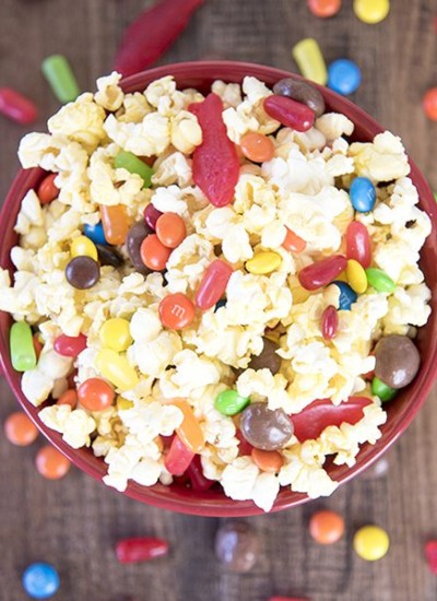 Above view of movie theater popcorn mix in a red bowl.