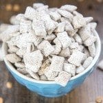Angled view of scotcheroo muddy buddies in a blue bowl.