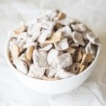 Angled view of snickerdoodle muddy buddies in a white bowl.