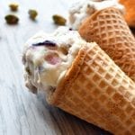 Close up view for fig pistachio ice cream cones on a light backdrop.