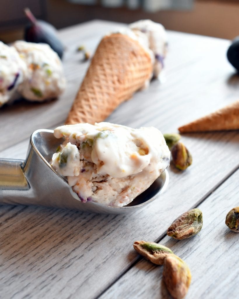 Angled view for fig pistachio ice cream cones on a light backdrop.
