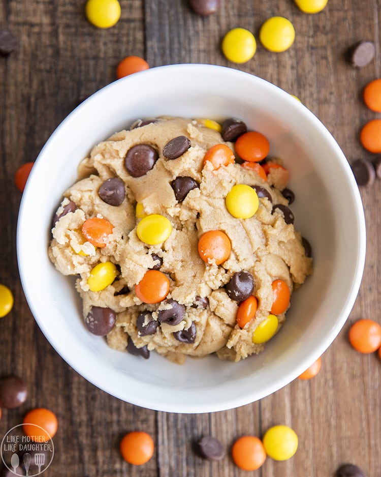 A bowl for one of edible peanut butter cookie dough with reeses pieces and chocolate chips 