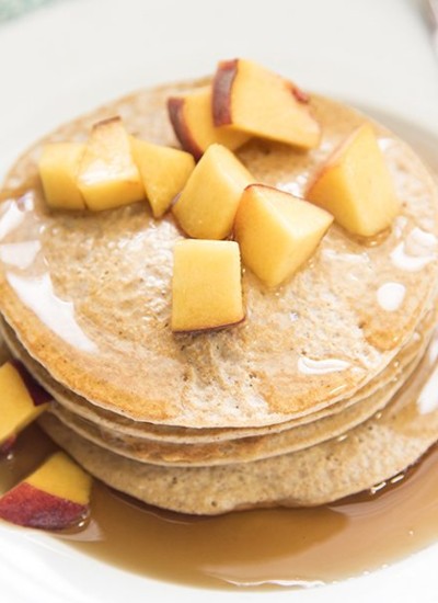 Angled view of biggest loser pancakes stacked on a white plate.