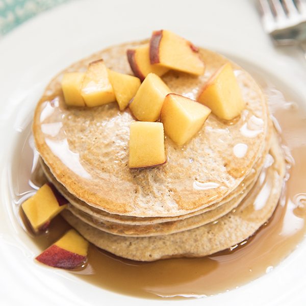 Angled view of biggest loser pancakes stacked on a white plate.