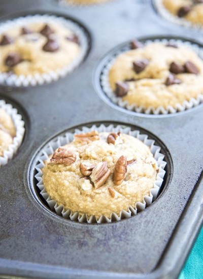 Angled view of peanut butter, banana, and oat blender muffins in a pan.