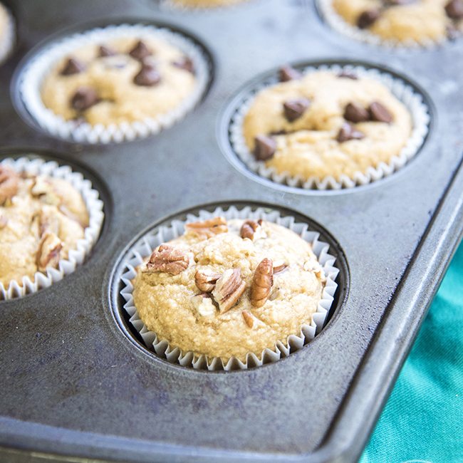 Angled view of peanut butter, banana, and oat blender muffins in a pan.