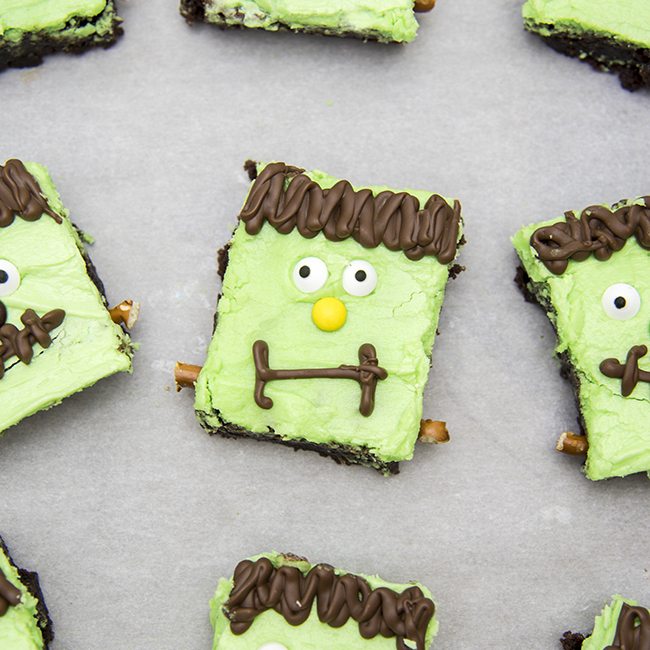 Above view of frankenstein brownies on parchment paper.