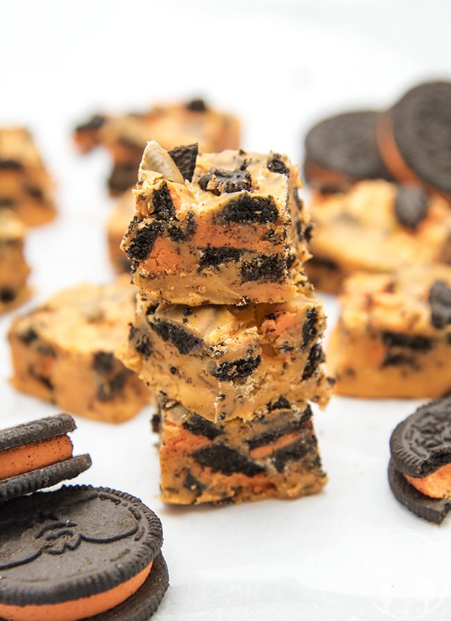 Angled view of halloween cookies and cream fudge stacked on top of each other.