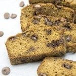 Angled view of healthier pumpkin chocolate chip bread on a white plate.