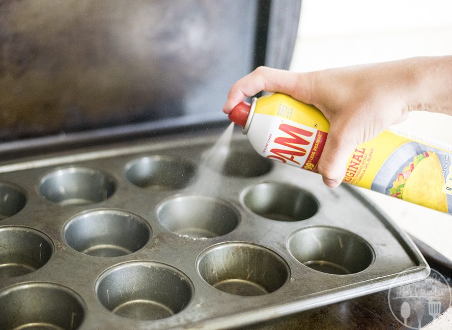 This is an image of cooking spray being used on a baking sheet