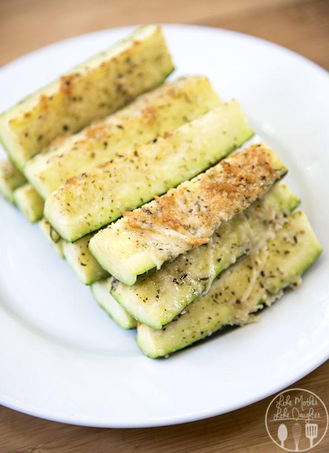 A stack of parmesan topped zucchini spears. 