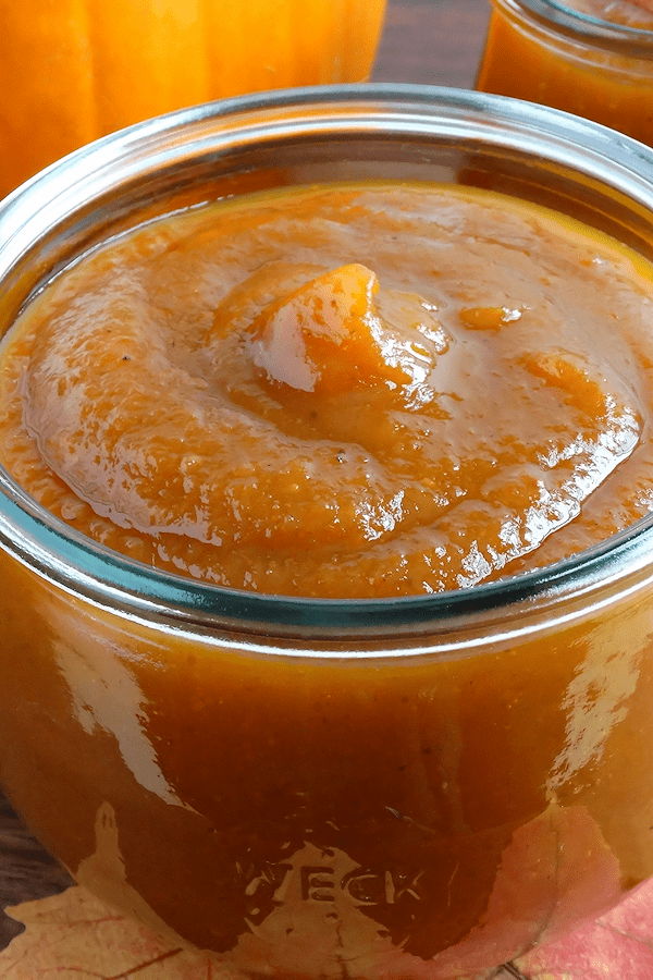 Close up of homemade pumpkin butter in a glass jar.