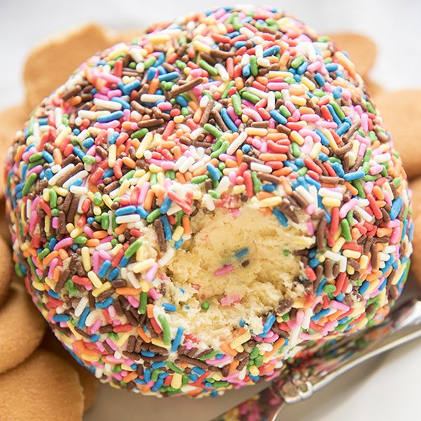 A cake batter cheeseball covered in sprinkles.