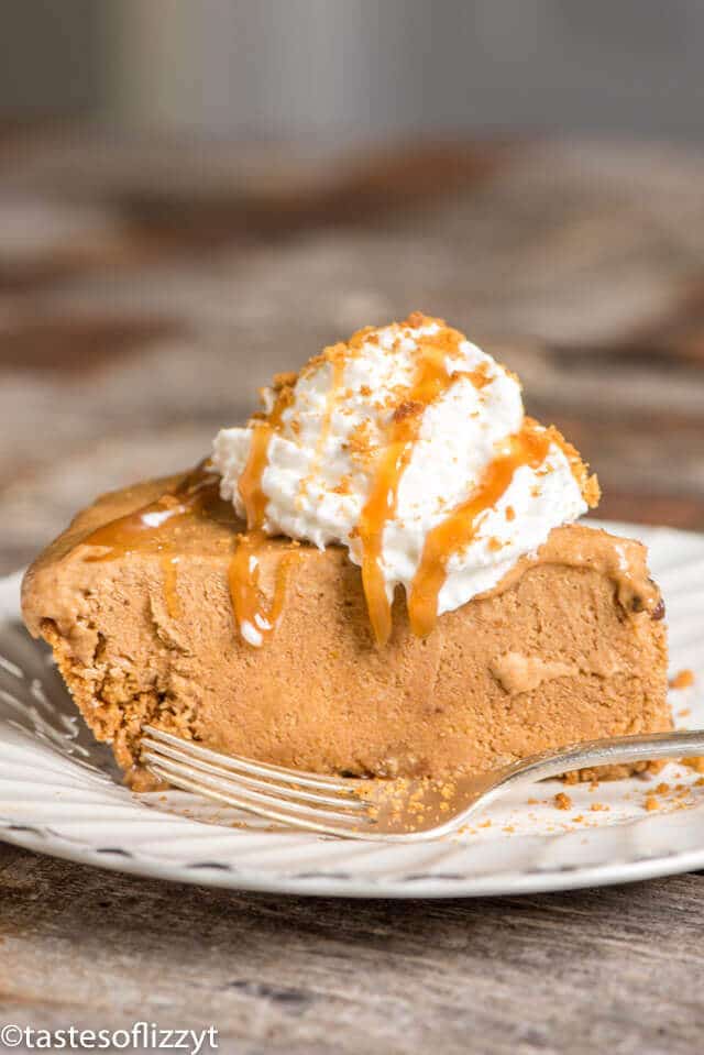 Side view of frozen pumpkin pie on a plate with a fork.
