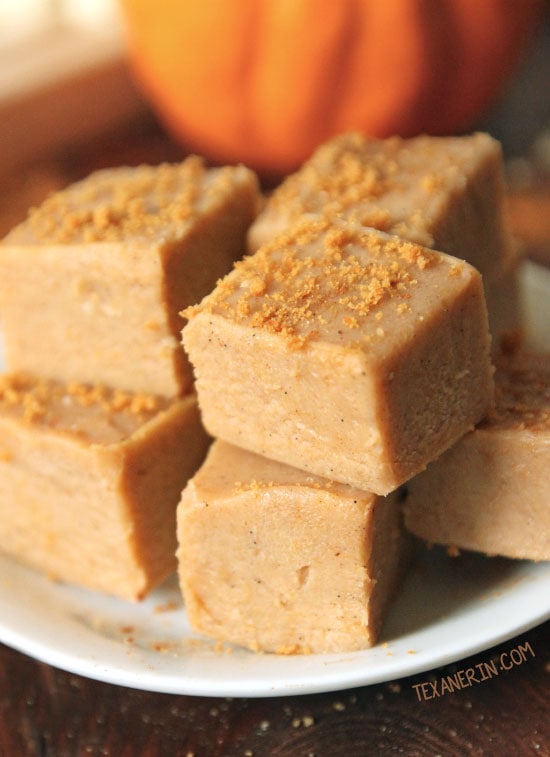 Close up of cubes of pumpkin fudge stacked on a plate.