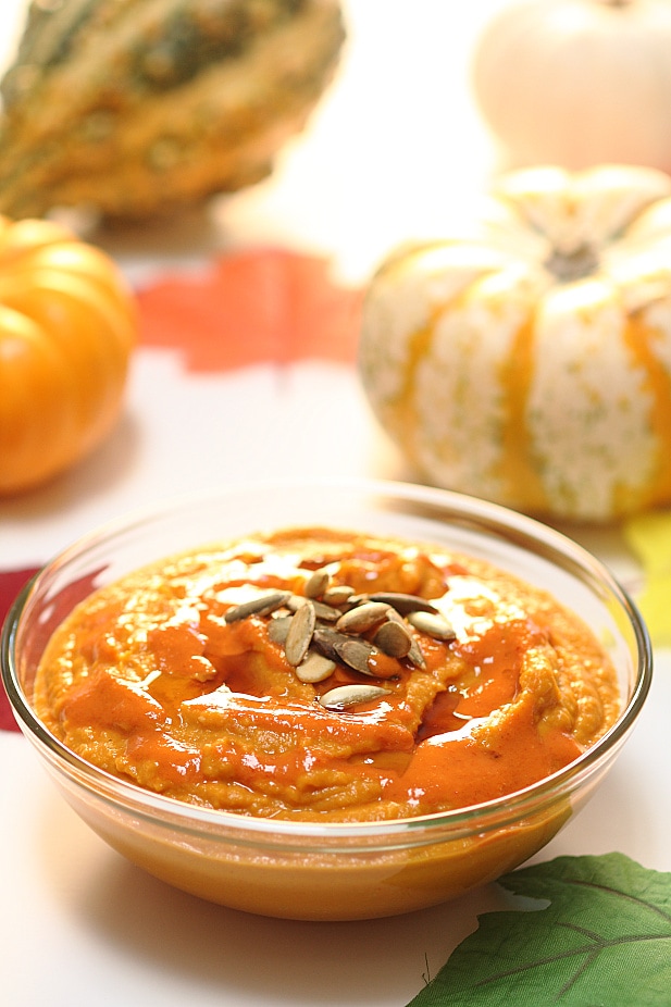 Close up of thai red curry pumpkin hummus in a glass bowl.