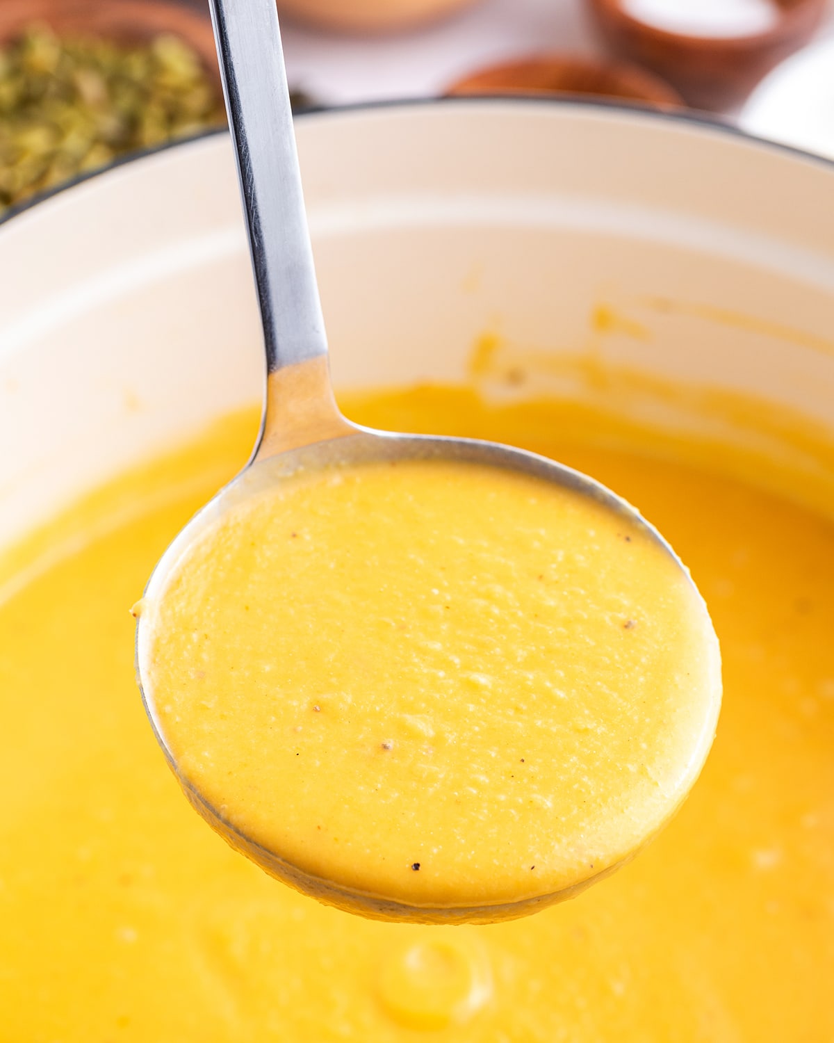 A ladle of autumn squash soup.