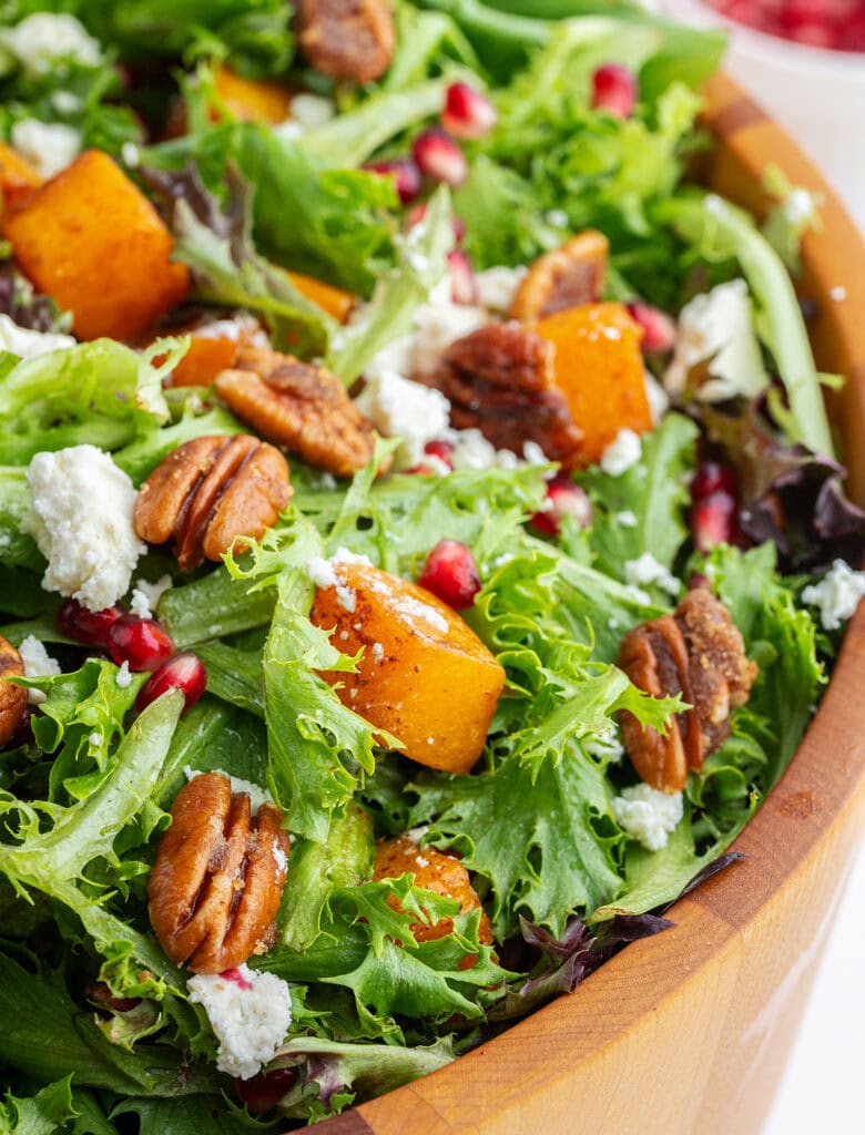 A close up of Roasted Butternut Squash Salad with feta and pomegranate pieces.