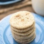 Angled view of stacked eggnog cookies on a blue plate.