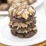 A stack of three chocolate cookies topped with German chocolate frosting.