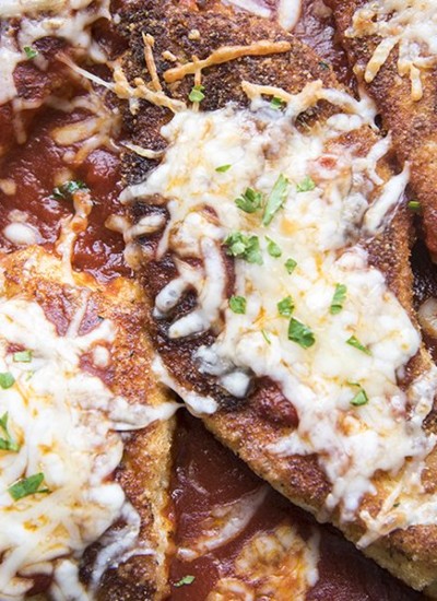 Close up of chicken parmesan with melted cheese.