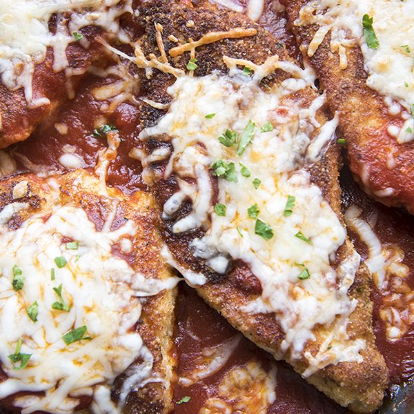 Close up of chicken parmesan with melted cheese.