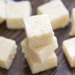 A stack of three pieces of eggnog fudge topped with nutmeg.