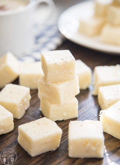 Eggnog fudge pieces on a wooden board.