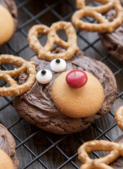 Angled view of reindeer cookies on a cooling rack.