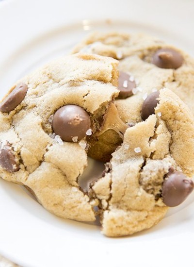 Angled view of rolo stuffed chocolate chip cookies on a white plate.