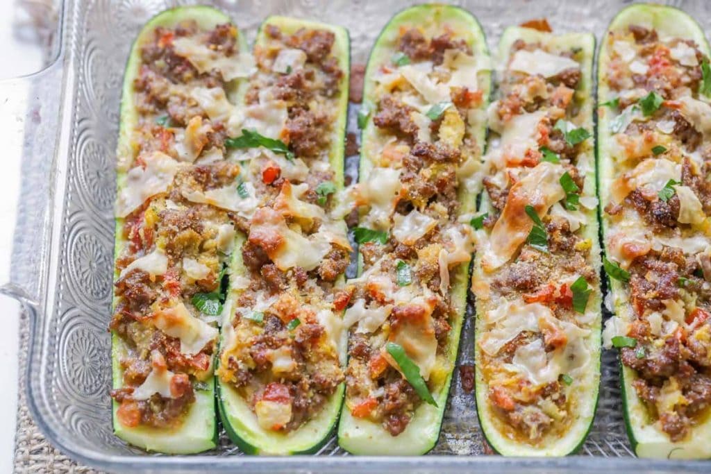 Zucchini stuffed with sausage, tomatoes, and topped with mozzarella cheese.