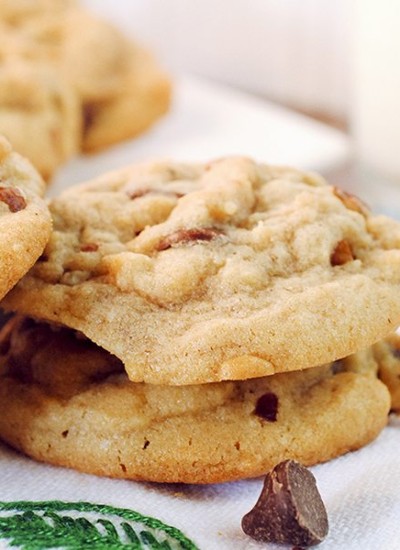 Angled image of butter pecan cookies stacked on each other.