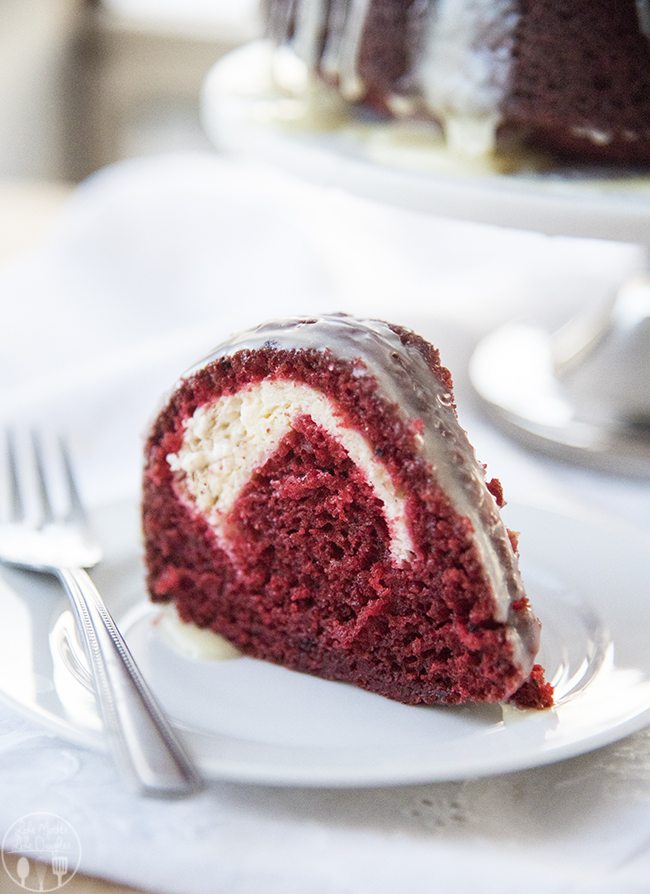 Angled image of a slice of cream cheese stuffed red velvet cake.