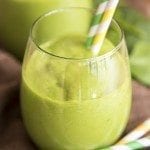 Angled image of a tropical green smoothie in a glass.