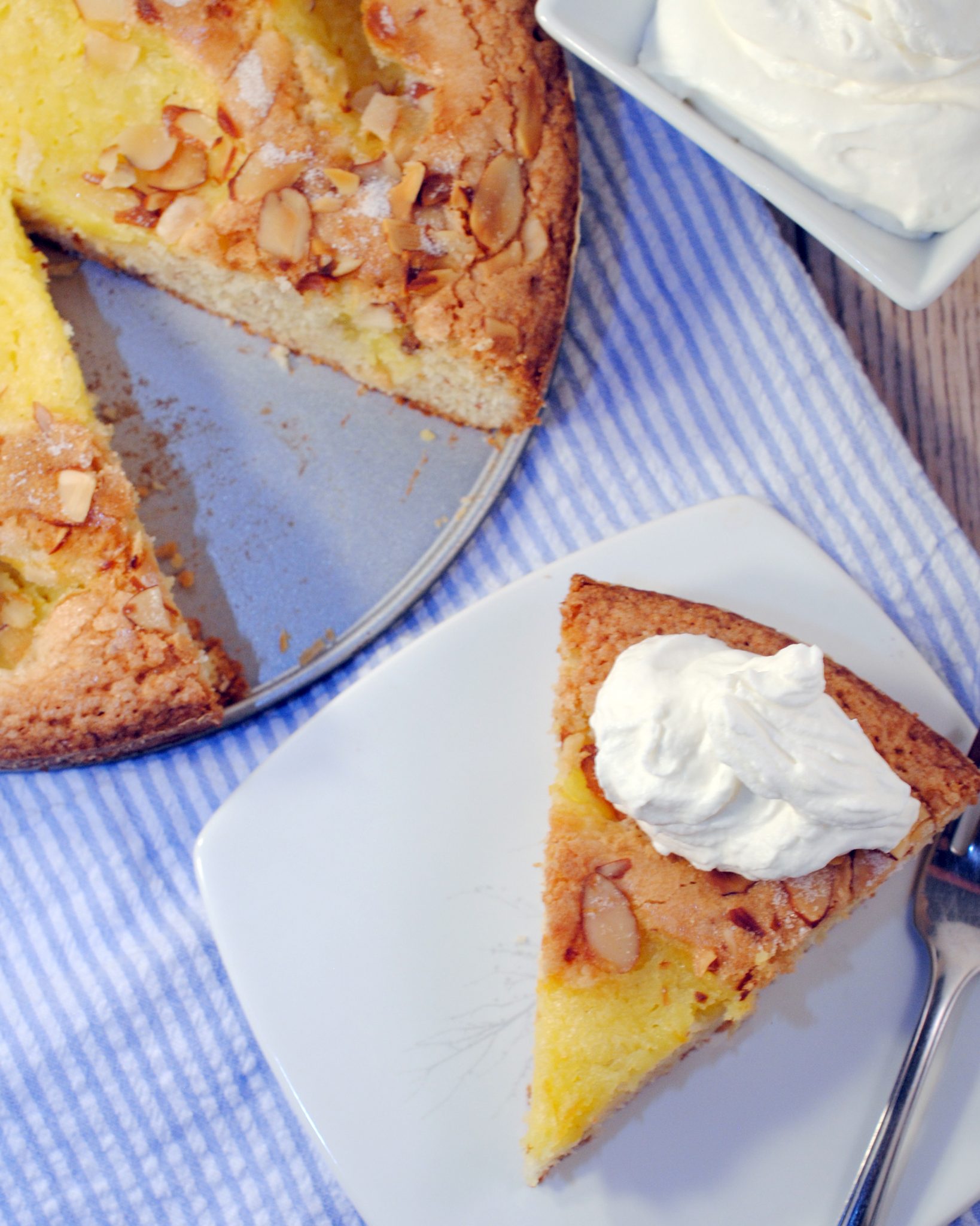 An almond lemon curd cake baked like a citrus tart with all the goodness of toasted almonds and lemon curd in a torta.