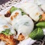 Close up image of roasted jerk chicken with spinach and mozzarella.