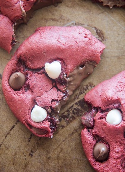 Above image of nutella stuffed red velvet cookies with filling visible.