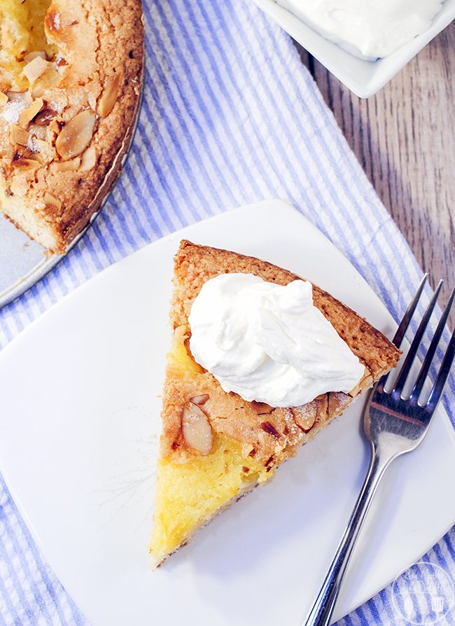 Above image of almond lemon curd torta on a white plate.