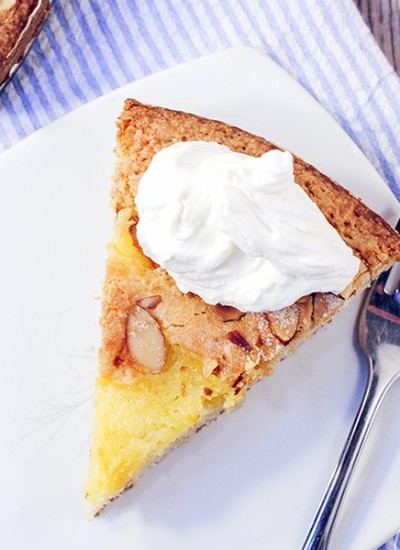 Above image of almond lemon curd torta on a white plate.