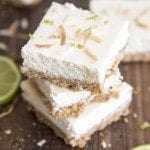 Angled image of lime cheesecake bars stacked on top of each other.
