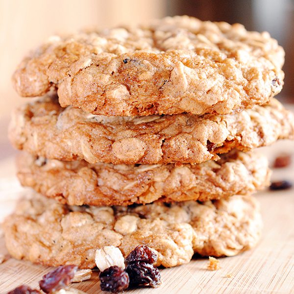 Close up image of oatmeal raisin cookies stacked up on each other.