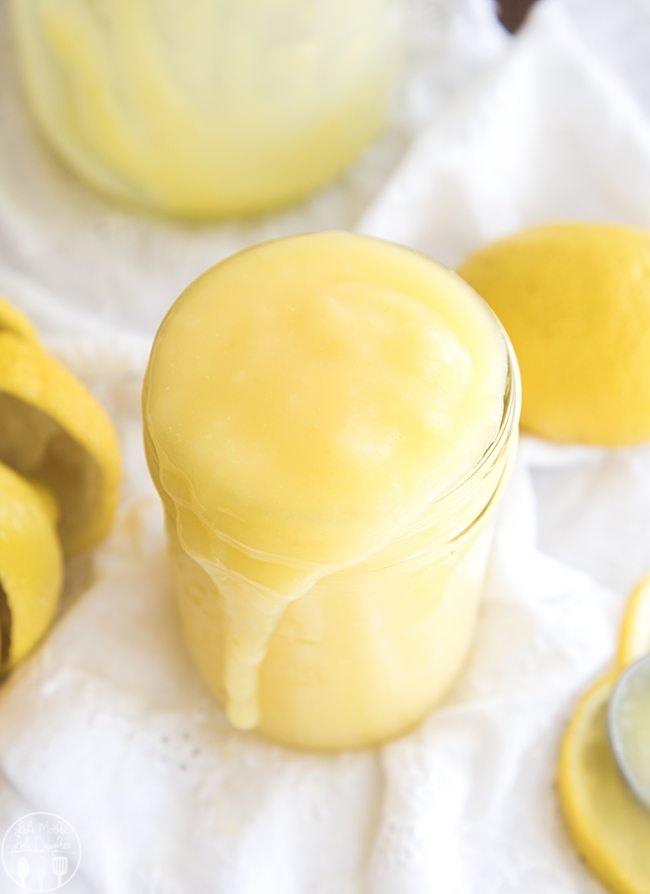 Above image of lemon curd pouring over a mason jar.