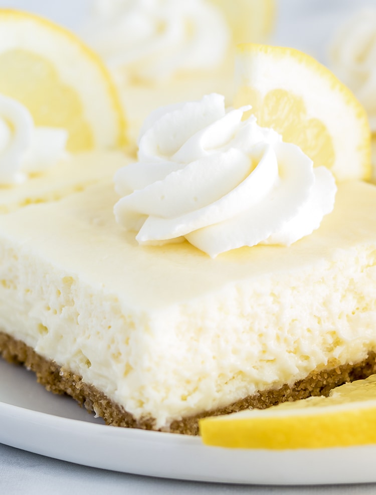Lemon Cheesecake Bar with whipped cream on top