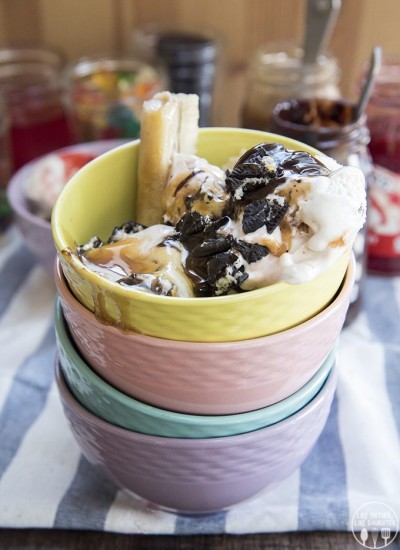 Banana split bars in a stack of colorful bowls.