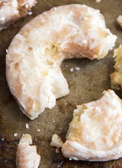 A close up of a crumbled old fashioned donut.