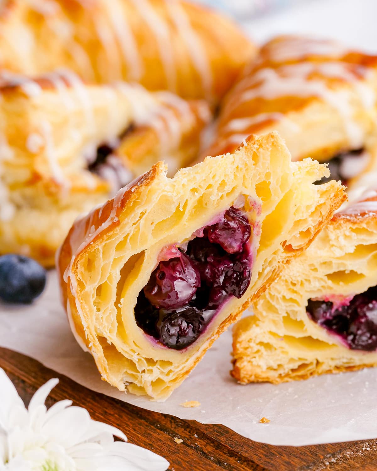 A blueberry turnover cut in half to show the flaky layers, and the blueberry filling.