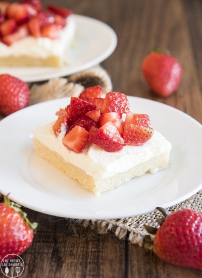 A slice of angel food cake sugar cookie bars with strawberries on top.