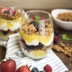 Side image of lemon curd and berry parfait in a glass cup.