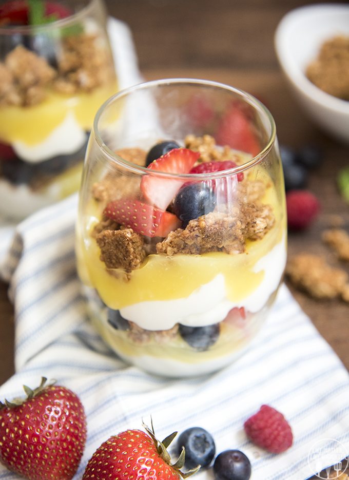 A lemon parfait with layers of lemon curd, granola, yogurt, and berries. 